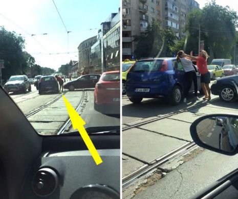 IMAGINI ŞOCANTE surprinse pe un bulevard din Bucureşti! Două şoferiţe S-AU LUAT LA BĂTAIE! Femeia în ROŞU i-a dat un pumn rivalei şi...