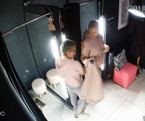 INCREDIBIL. Femeie filmata de doua ori furând haine dintr-un magazin