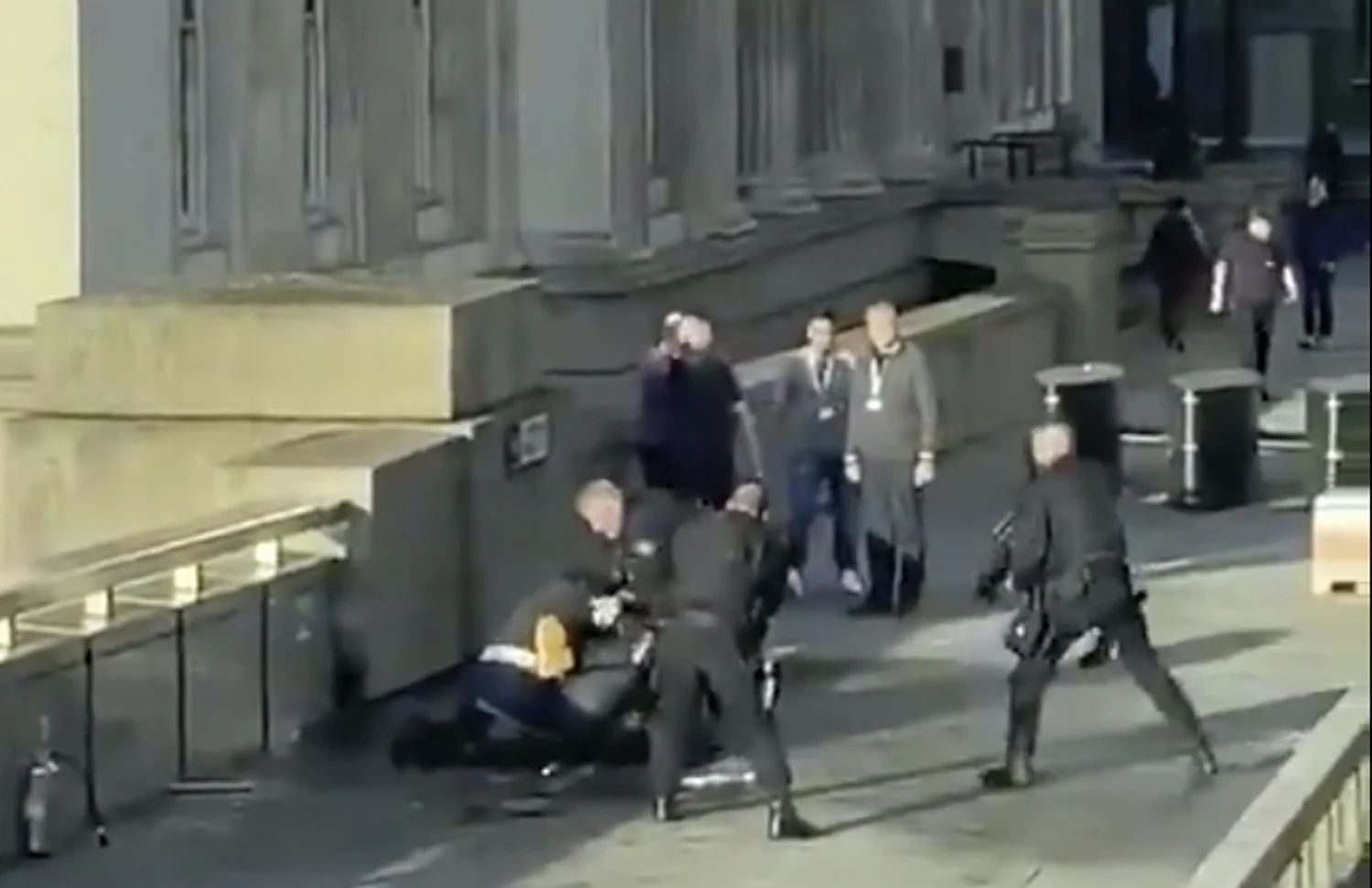 In this grab taken from video made available by @HLOBlog, a man is surrounded by armed police after an incident on London Bridge, in London, Friday, Nov. 29, 2019. A man wearing a fake explosive vest stabbed several people before being tackled by members of the public and then shot dead by armed officers on London Bridge, police and the city’s mayor say. Police say they are treating it as a terrorist attack. (@HLOBlog via AP)