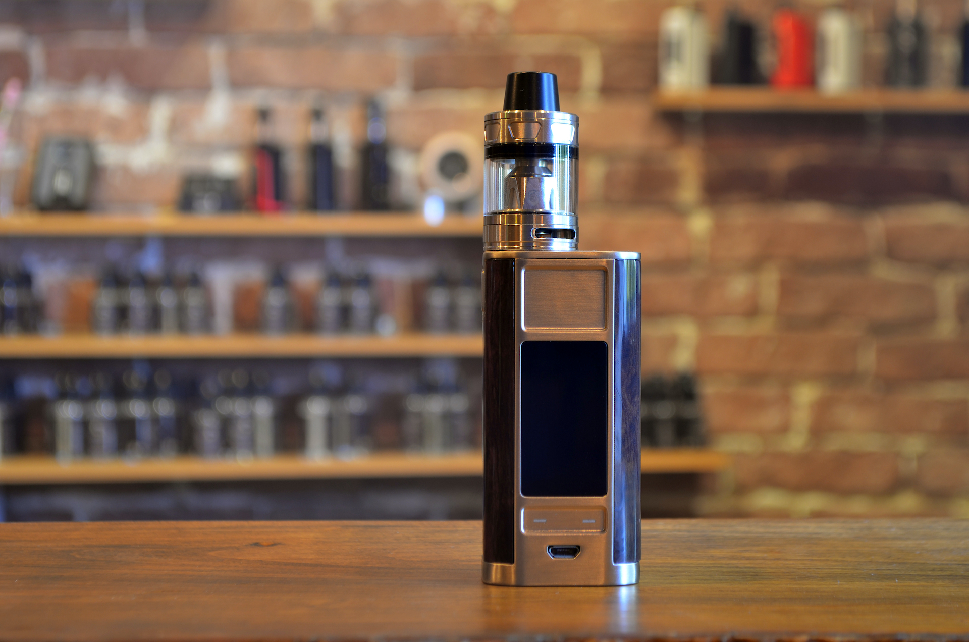 Electronic cigarette on a background of vape shop. E-cigarette for vaping. Popular vape devices